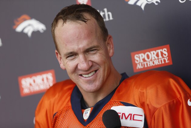 Denver Broncos quarterback Peyton Manning jokes with reporters after an NFL football scrimmage at the Broncos' headquarters Wednesday, Aug. 26, 2015, in Englewood, Colo. (AP Photo/David Zalubowski)