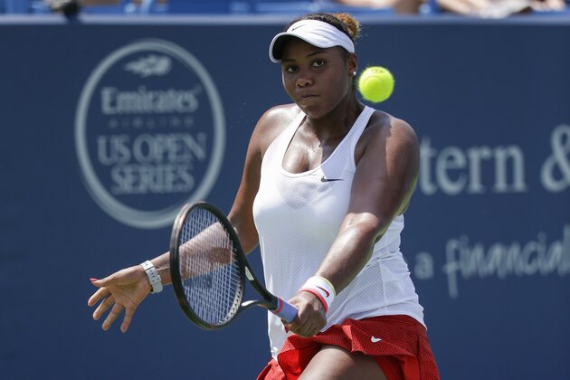 Taylor Townsend, of the United States, returns a serve against Anna Karolina Schmiedlova, of Slovakia, during the qualifying round at the Western & Southern Open tennis tournament, Saturday, Aug. 15, 2015, in Mason, Ohio. (AP Photo/John Minchillo)