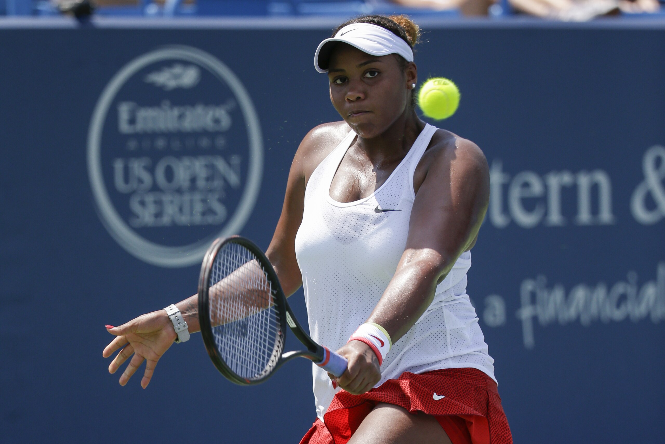 Taylor Townsend, of the United States, returns a serve against Anna Karolina Schmiedlova, of Slovakia, during the qualifying round at the Western & Southern Open tennis tournament, Saturday, Aug. 15, 2015, in Mason, Ohio. (AP Photo/John Minchillo)