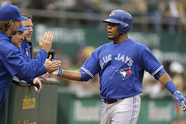 Toronto Blue Jays' Edwin Encarnacion is congratulated after hitting a home run off Oakland Athletics Kendall Graveman in the second inning of a baseball game Tuesday, July 21, 2015, in Oakland, Calif. (AP Photo/Ben Margot)