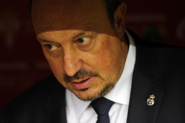 Real Madrid's coach Rafael Benitez is pictured on the bench before the start of the Spanish league football match Sporting Gijon vs Real Madrid CF at the El Molinon stadium in Gijon on August 23, 2015. The match finished with a 0-0 draw.   AFP PHOTO/ MIGUEL RIOPA        (Photo credit should read MIGUEL RIOPA/AFP/Getty Images)