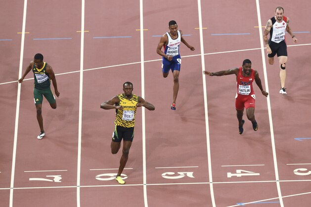 Jamaica's Usain Bolt (front) reacts as he wins ahead of (L-R) South Africa's Anaso Jobodwana, Britain's Zharnel Hughes, USA's Justin Gatlin and Turkey's Ramil Guliyev in the final of the men's 200 metres athletics event at the 2015 IAAF World Championships at the 'Bird's Nest' National Stadium in Beijing on August 27, 2015.   AFP PHOTO / ANTONIN THUILLIER        (Photo credit should read ANTONIN THUILLIER/AFP/Getty Images)