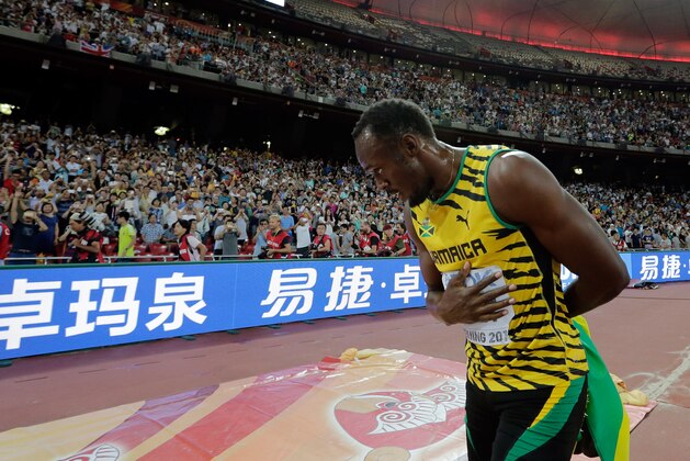 Jamaica's Usain Bolt bows to the crowd as he celebrates after winning the gold in the men's 200m final at the World Athletics Championships at the Bird's Nest stadium in Beijing, Thursday, Aug. 27, 2015. (AP Photo/Andy Wong)