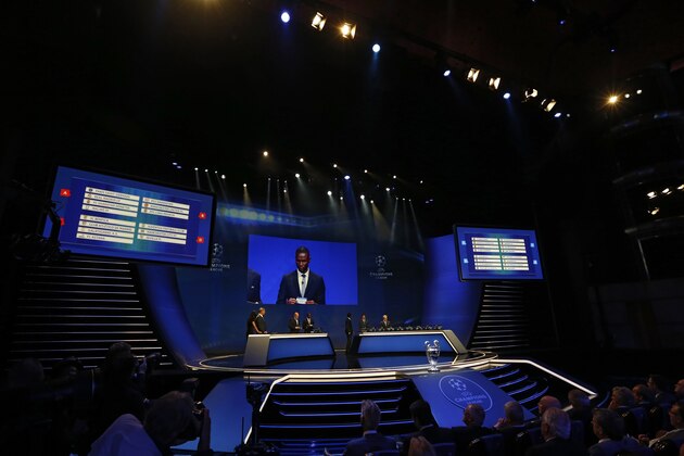 Former French football player Eric Abidal (screen) takes part in the UEFA Champions League Group stage draw ceremony, on August 27, 2015 in Monaco. AFP PHOTO / VALERY HACHE        (Photo credit should read VALERY HACHE/AFP/Getty Images)