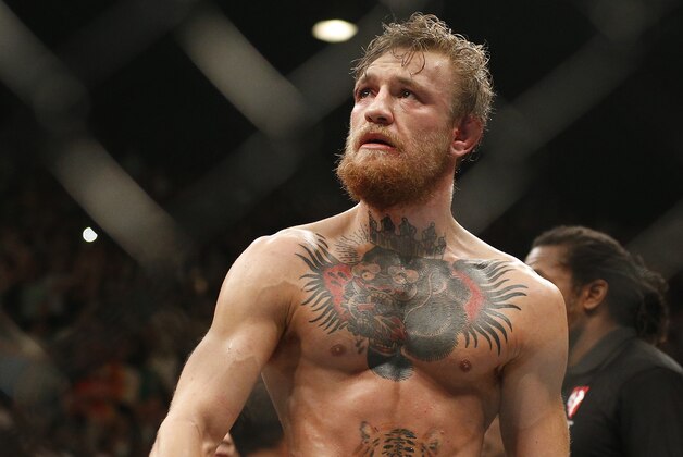 Conor McGregor celebrates after defeating Chad Mendes during their interim featherweight title mixed martial arts bout at UFC 189 Saturday, July 11, 2015, in Las Vegas. (AP Photo/John Locher)