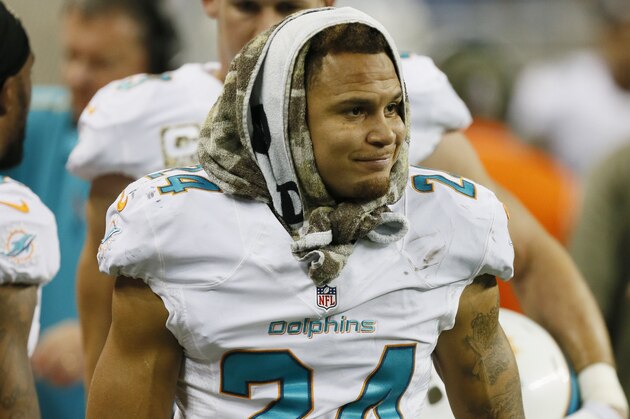 Miami Dolphins cornerback Cortland Finnegan (24) is seen on the bench area during the second half of an NFL football game against the Detroit Lions in Detroit, Sunday, Nov. 9, 2014. (AP Photo/Paul Sancya)