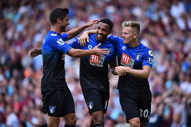 Bournemouth's English striker Callum Wilson (2nd L), Bournemouth's South African-born English midfielder Andrew Surman (L) and Bournemouth's English midfielder Matt Ritchie (R) celebrate Wilson's second goal during the English Premier League football match between West Ham United and Bournemouth at The Boleyn Ground in Upton Park, East London on August 22, 2015. AFP PHOTO / BEN STANSALL

RESTRICTED TO EDITORIAL USE. No use with unauthorized audio, video, data, fixture lists, club/league logos or 'live' services. Online in-match use limited to 75 images, no video emulation. No use in betting, games or single club/league/player publications.        (Photo credit should read BEN STANSALL/AFP/Getty Images)