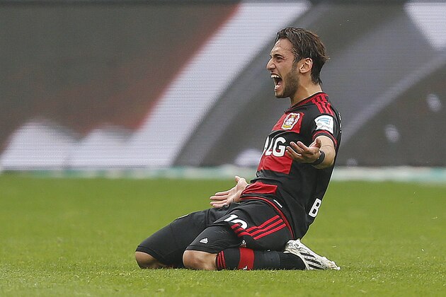 Leverkusen's Hakan Calhanoglu from Turkey celebrates after scoring the opening goal during the German first division Bundesliga soccer match between Bayer Leverkusen and TSG Hoffenheim in Leverkusen, Germany, Saturday, May 16, 2015. (AP Photo/Frank Augstein)