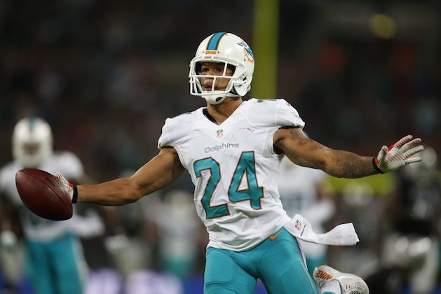 Miami Dolphins' Cortland Finnegan celebrates after recovering a fumbled snap for a touchdown during the second half of an NFL football game against the Oakland Raiders, Sunday, Sept. 28, 2014, at Wembley Stadium in London. (AP Photo/Lefteris Pitarakis)