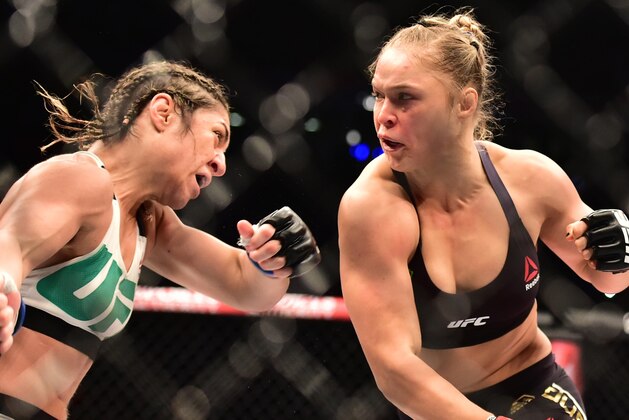 Aug 1, 2015; Rio de Janeiro, RJ, Brazil; Ronda Rousey (red gloves) fights Bethe Correia (blue gloves) during UFC 190 at HSBC Arena. Mandatory Credit: Jason Silva-USA TODAY Sports