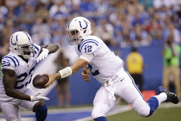 Indianapolis Colts quarterback Andrew Luck (12) hands off to running back Frank Gore (23) in the first half of an NFL preseason football game against the Chicago Bears in Indianapolis, Saturday, Aug. 22, 2015.  (AP Photo/AJ Mast)