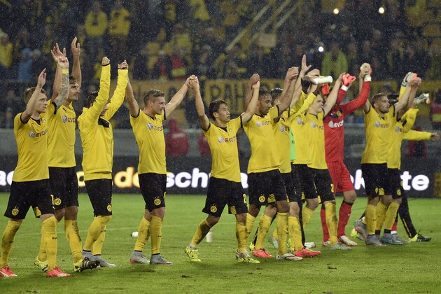 Dortmund's players celebrate after winning  the Europa League play-off 2nd leg soccer match between Borussia Dortmund and Odds BK in Dortmund, Germany, Thursday, Aug. 27, 2015. Borussia defeated Odds with 7-2.  (AP Photo/Martin Meissner)