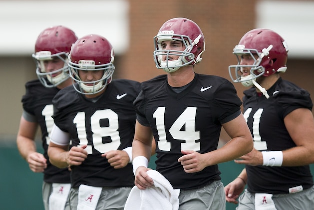 Alabama quarterbacks, from left, David Cornwell, Cooper Bateman, Jake Coker and Alec Morris, runs drills with other quarterbacks during NCAA college football practice, Thursday, Aug. 6, 2015, in Tuscaloosa, Ala. (AP Photo/Brynn Anderson)