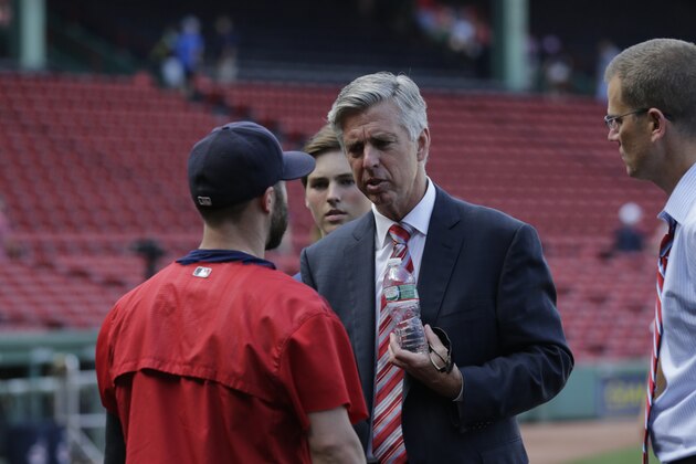 Boston Red Sox president of baseball operations Dave Dombrowski talks with second baseman Dustin Pedroia prior to a baseball game at Fenway Park in Boston, Wednesday, Aug. 19, 2015. (AP Photo/Charles Krupa)