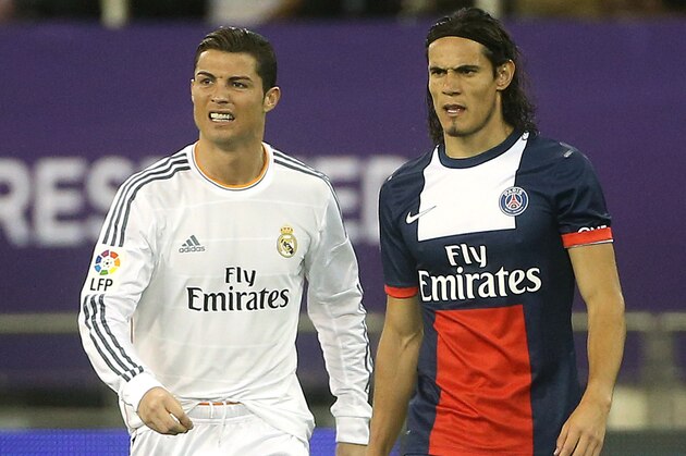 DOHA, QATAR - JANUARY 2: Cristiano Ronaldo of Real Madrid and Edinson Cavani of PSG in action during the friendly match between Paris Saint-Germain FC and Real Madrid at the Khalifa Stadium on January 2, 2014 in Doha, Qatar. (Photo by John Berry/Getty Images)