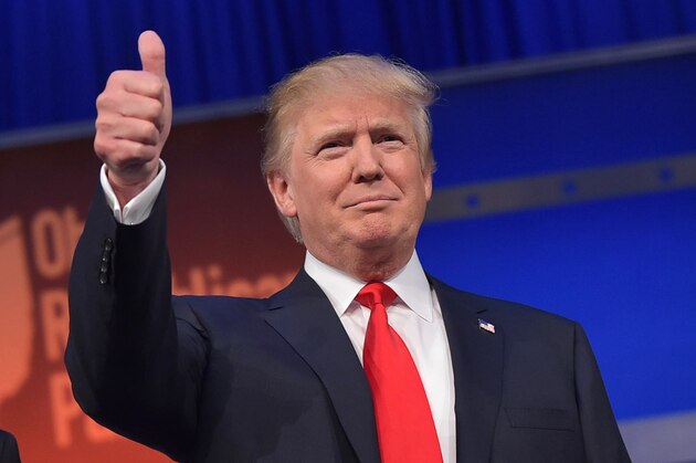 Real estate tycoon Donald Trump flashes the thumbs-up as he arrives on stage for the start of the prime time Republican presidential debate on August 6, 2015 at the Quicken Loans Arena in Cleveland, Ohio. AFP PHOTO/MANDEL NGAN        (Photo credit should read MANDEL NGAN/AFP/Getty Images)
