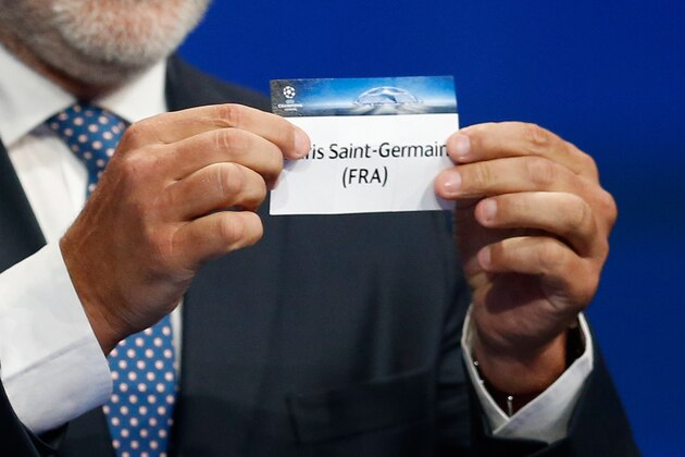 Former FC Barcelona player Andoni Zubizarreta shows the name of Paris Saint-Germain football club during the UEFA Champions League Group stage draw ceremony, on August 27, 2015 in Monaco. AFP PHOTO / VALERY HACHE        (Photo credit should read VALERY HACHE/AFP/Getty Images)