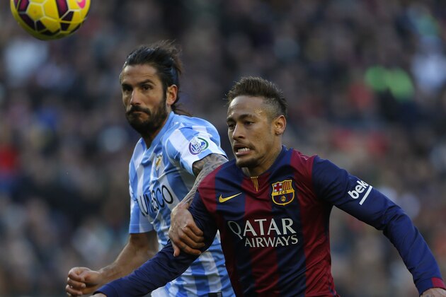 Barcelona's Neymar, right, fights for the ball against Malaga's Marcos Angeleri during a Spanish La Liga soccer match at the Camp Nou stadium in Barcelona, Spain, Saturday, Feb. 21, 2015. (AP Photo/Emilio Morenatti)
