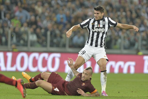 Juventus' forward Alvaro Morata challenges for the ball with Roma' Radja Nainggolan during a Serie A soccer match between Juventus and Roma at the Juventus stadium, in Turin, Italy, Sunday, Oct. 5, 2014. (AP Photo/ Massimo Pinca)