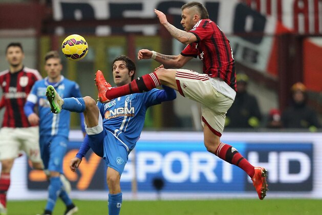 MILAN, ITALY - FEBRUARY 15:  Jeremy Menez (R) of Milan competes for the ball with Daniele Croce of Empoli during the Serie A match between AC Milan and Empoli FC at Stadio Giuseppe Meazza on February 15, 2015 in Milan, Italy.  (Photo by Maurizio Lagana/Getty Images)