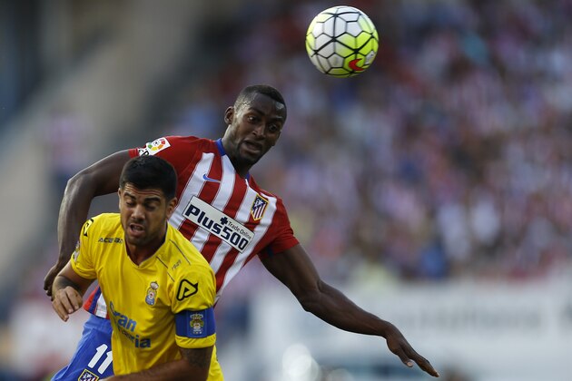 Atletico Madrid's Jackson Martinez, top, goes for a header with Las Palmas' Aythami Artiles during the Spanish La Liga soccer match between Atletico Madrid and Las Palmas at the Vicente Calderon stadium in Madrid, Spain, Saturday, Aug. 22, 2015. (AP Photo/Francisco Seco)