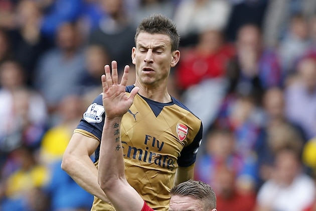 Crystal Palace's English striker Connor Wickham vies with Arsenal's French defender Laurent Koscielny (up) during the English Premier League football match between Crystal Palace and Arsenal at Selhurst Park in south London on August 16, 2015. AFP PHOTO / ADRIAN DENNISRESTRICTED TO EDITORIAL USE. No use with unauthorized audio, video, data, fixture lists, club/league logos or 'live' services. Online in-match use limited to 75 images, no video emulation. No use in betting, games or single club/league/player publications.        (Photo credit should read ADRIAN DENNIS/AFP/Getty Images)