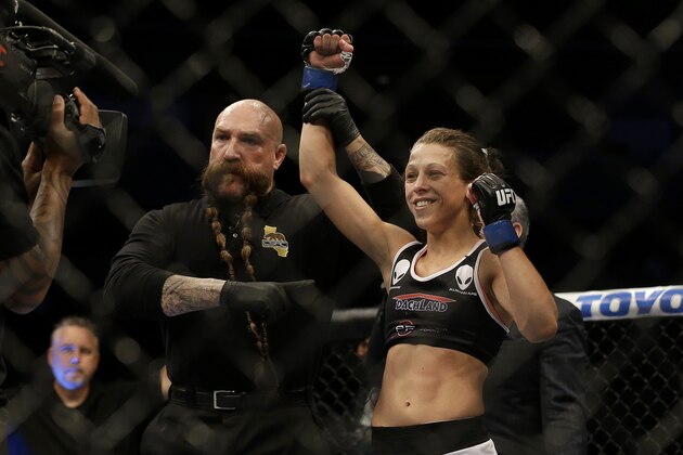 Joanna Jedrzejczyk, right, has her arm raised in victory by referee Mike Beltran after beating Juliana Lima by unanimous decision in a women's strawweight mixed martial arts bout at a UFC on Fox event in San Jose, Calif., Saturday, July 26, 2014. (AP Photo/Jeff Chiu)