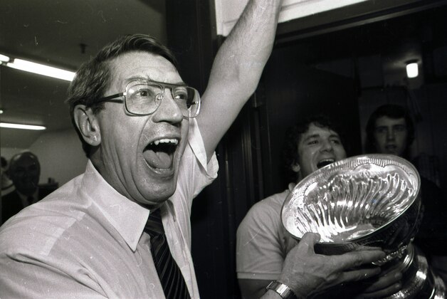 New York Islanders coach Al Arbour celebrates in the locker room as he drinks from the Stanley Cup after the Islanders won their fourth cup in a row, beating the Edmonton Oilers 4-2 to sweep the series at the Nassau Coliseum, Tuesday, May 17, 1983 in Uniondale, N.Y. (AP Photo/Pool)