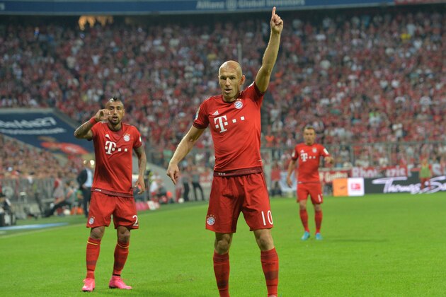 Bayern's Arjen Robben gestures as Bayern's Arturo Vidal, left, looks on during the German Bundesliga soccer match between FC Bayern Munich and Hamburger SV in Munich, southern Germany, Friday, Aug. 14, 2015. (AP Photo/Kerstin Joensson)
