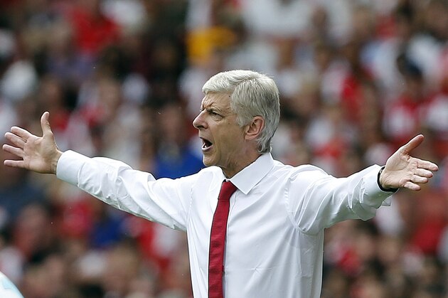 Arsenal's manager Arsene Wenger gestures during the English Premier League soccer match between Arsenal and West Ham at the Emirates stadium in London, Sunday, Aug. 9, 2015.(AP Photo/Frank Augstein)