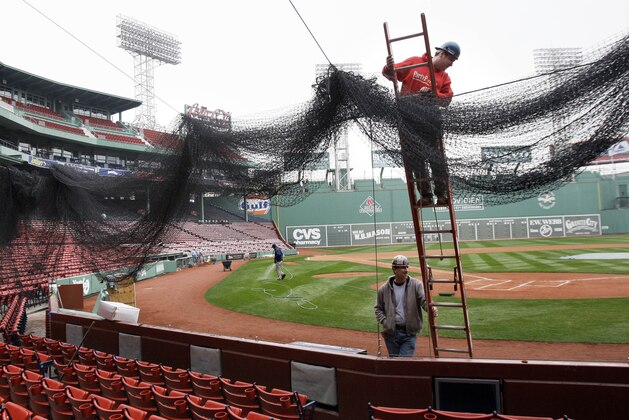Local 7 ironworkers Kevin McConologue (on ladder) and Scott White (below) put protective netting in place over the seating behind home plate at Fenway Park in Boston Thursday, April 2, 2009 as preparations are underway for Monday's Boston Red Sox home opener against the Tampa Bay Rays. (AP Photo/Elise Amendola)