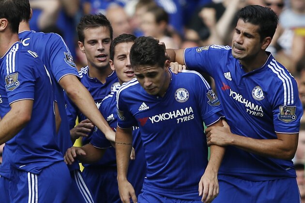 Chelsea's Brazilian-born Spanish striker Diego Costa (R) congratulates Chelsea's Brazilian midfielder Oscar (2R) after Oscar scored the opening goal during the English Premier League football match between Chelsea and Swansea City at Stamford Bridge in London on August 8, 2015. AFP PHOTO / ADRIAN DENNIS

RESTRICTED TO EDITORIAL USE. No use with unauthorized audio, video, data, fixture lists, club/league logos or 'live' services. Online in-match use limited to 75 images, no video emulation. No use in betting, games or single club/league/player publications.        (Photo credit should read ADRIAN DENNIS/AFP/Getty Images)