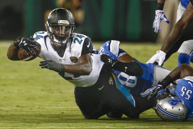 Aug 28, 2015; Jacksonville, FL, USA;  Jacksonville Jaguars running back T.J. Yeldon (24) carries the ball as Detroit Lions defensive end Devin Taylor (98) tackles during the first quarter of  an NFL preseason football game at EverBank Field. Mandatory Credit: Reinhold Matay-USA TODAY Sports