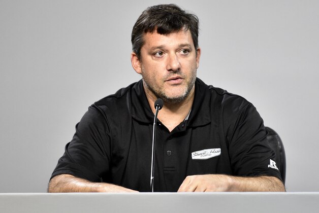 NASCAR auto racing driver Tony Stewart reads a statement during a news conference at Atlanta Motor Speedway in Hampton, Ga., Friday, Aug. 29, 2014. Stewart says the death of Kevin Ward Jr. will