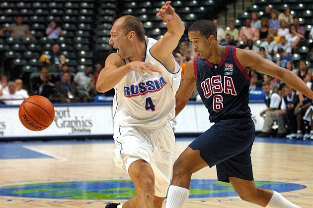 INDIANAPOLIS, IN - SEPTEMBER 2:  Guard Andre Miller (R) of the United States goes after a ball that guard Vassili Karassev (L) of Russia lost control of 02 September 2002 at the Conseco Fieldhouse in Indianapolis IN during the FIBA World Basketball Championships.  (Photo credit should read JOHN RUTHROFF/AFP/Getty Images)