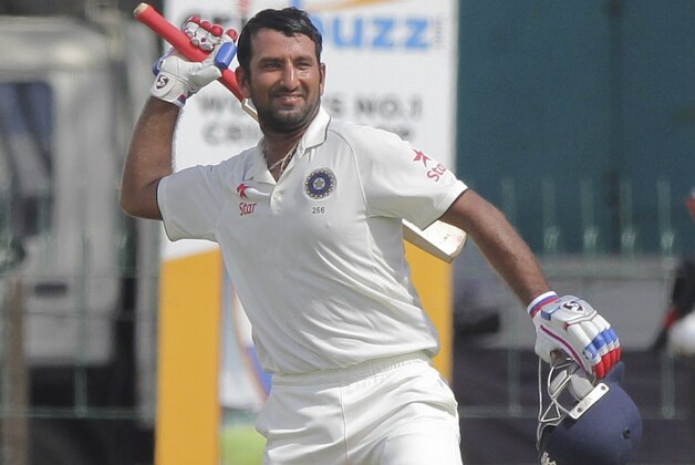 India's Cheteshwar Pujara, celebrates scoring hundred runs on the second day of their third test cricket match against Sri Lanka in Colombo, Sri Lanka, Saturday, Aug. 29, 2015. (AP Photo/Eranga Jayawardena)
