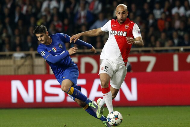 Juventus' Alvaro Morata, left is challenged by Monaco's Aymen Abdennour during the Champions League quarterfinal second leg soccer match between Monaco and Juventus at Louis II stadium in Monaco, Wednesday, April 22, 2015. (AP Photo/Michel Euler)