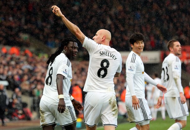 SWANSEA, WALES - FEBRUARY 21: Jonjo Shelvey (C) of Swansea celebrates his goal with team mate Bafetimbi Gomis, making the score 2-1 to his team during the Barclays Premier League match between Swansea City and Manchester United at Liberty Stadium on February 21, 2015 in Swansea, Wales. (Photo by Athena Pictures/Getty Images)