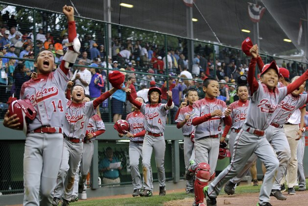 Japan's Yugo Aoki (4) celebrate with teammates after hitting the game-winning RBI single off Venezuela's Johan Garcia during the eighth inning of an international double-elimination baseball game at the Little League World Series, Wednesday, Aug. 26, 2015, in South Williamsport, Pa. Japan won 5-4. (AP Photo/Matt Slocum)