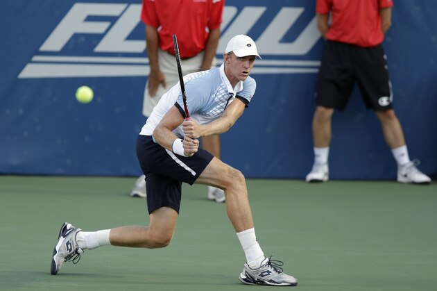 Kevin Anderson, of South Africa, returns a shot to Malek Jaziri, of Tunisia, during a semifinal at the Winston-Salem Open tennis tournament in Winston-Salem, N.C., Friday, Aug. 28, 2015. (AP Photo/Gerry Broome)