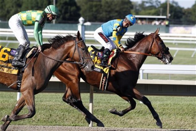 Jockey Victor Espinoza, right, on Triple Crown winner American Pharoah(4), smiles as he looks back at jockey Kent Desormeaux on Keen Ice (6) after American Pharoah won the Haskell Invitational horse race at Monmouth Park in Oceanport, N.J., Sunday, Aug. 2, 2015. Keen Ice  was second. (AP Photo/Mel Evans)