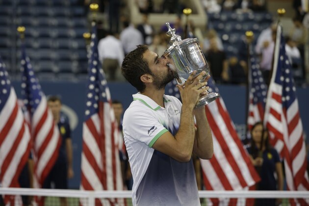 Marin Cilic, of Croatia, kisses the championship trophy after defeating Kei Nishikori, of Japan, in the championship match of the 2014 U.S. Open tennis tournament, Monday, Sept. 8, 2014, in New York. (AP Photo/Darron Cummings)