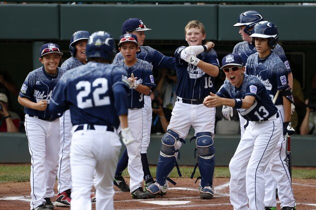 Lewisberry, Pa.'s Cole Wagner (22) runs home to a celebration by teammates after hitting a solo-home run off Pearland, Texas' Ryan Farmer during the first inning of the United States championship baseball game at the Little League World Series tournament in South Williamsport, Pa., Saturday, Aug. 29, 2015. (AP Photo/Gene J. Puskar)