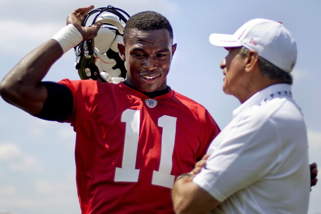 Atlanta Falcons wide receiver Julio Jones, left, talks with team owner Arthur Blank during NFL football minicamp, Tuesday, June 19, 2012, in Flowery Branch, Ga. (AP Photo/David Goldman)