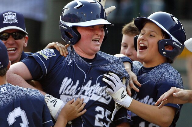 Lewisberry, Pa.'s Chayton Krauss (25)  celebrates with teammate Adam Cramer (10) after driving in the game-winning run with a walk-off single off Pearland, Texas' Marco Gutierrez in the sixth inning of the United States championship baseball game at the Little League World Series tournament in South Williamsport, Pa., Saturday, Aug. 29, 2015. Lewisberry, Pa. won 3-2. (AP Photo/Gene J. Puskar)