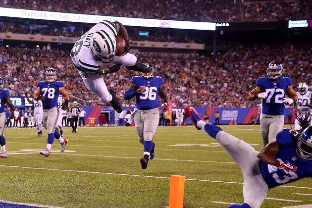 EAST RUTHERFORD, NJ - AUGUST 29:  Zac Stacy #38 of the New York Jets jumps over  Brandon Meriweather #43 of the New York Giants to score a touchdown in the second quarter during preseason action at MetLife Stadium on August 29, 2015 in East Rutherford, New Jersey.  (Photo by Elsa/Getty Images)