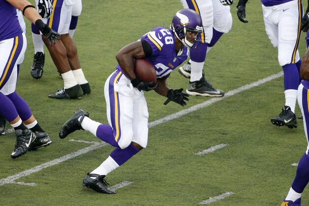 Minnesota Vikings running back Adrian Peterson (28) takes a hand off during warm ups before an NFL preseason football game in Canton, Ohio,  Sunday, Aug. 9, 2015. (AP Photo/Gene J. Puskar)