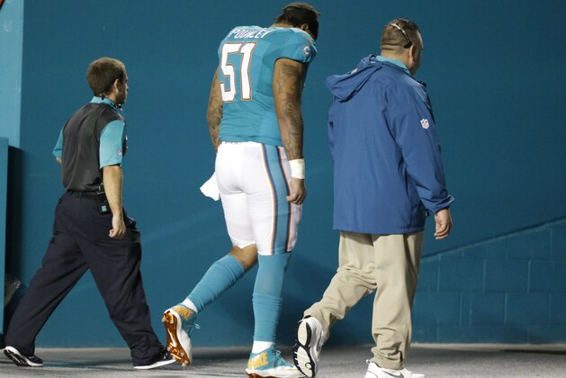 Miami Dolphins guard Mike Pouncey (51) is lead off the field during the first half of an NFL preseason football game against the Atlanta Falcons, Saturday, Aug. 29, 2015 in Miami Gardens, Fla. (AP Photo/Wilfredo Lee) Miami Dolphins guard Mike Pouncey (51) is lead off the field during the first half of an NFL preseason football game against the Atlanta Falcons, Saturday, Aug. 29, 2015 in Miami Gardens, Fla. (AP Photo/Wilfredo Lee)