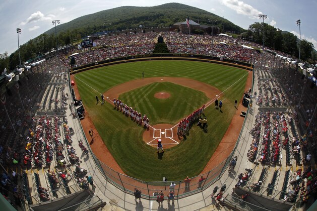 The Little League teams from Mexico, along the third baseline, and Japan are introduced before the International championship baseball game in Lamade Stadium at the Little League World Series tournament in South Williamsport, Pa., Saturday, Aug. 29, 2015. (AP Photo/Gene J. Puskar)