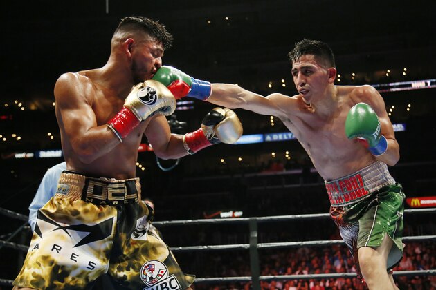 Leo Santa Cruz, right, lands a punch against Abner Mares during the seventh round of their WBC diamond featherweight and WBA featherweight championship boxing bout, Saturday, Aug. 29, 2015, in Los Angeles. (AP Photo/Danny Moloshok)